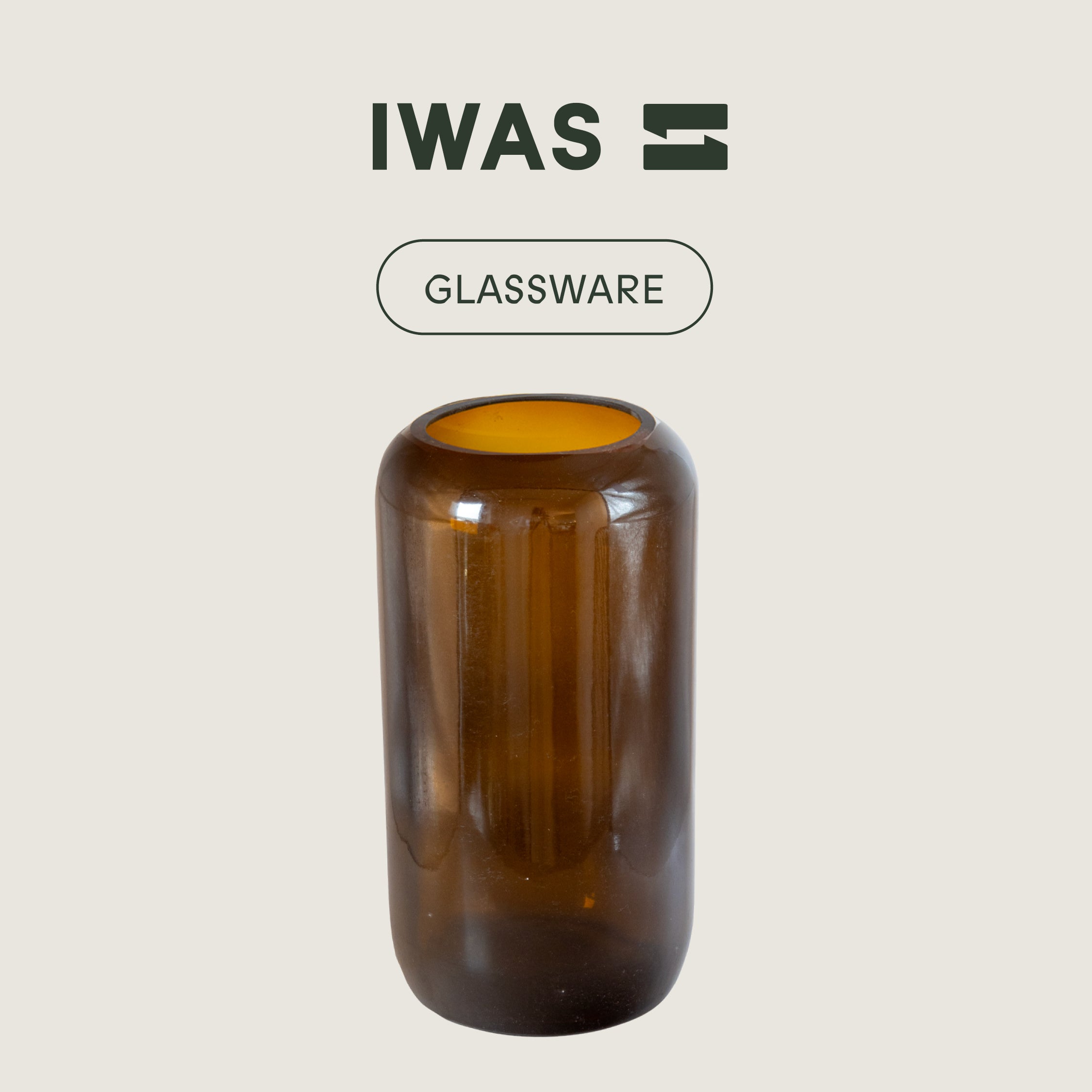 A large cylindrical glass vase with a dark tint and a top loop, labeled with 'IWAS' and 'GLASSWARE'.